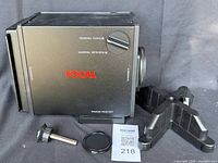 Main unit laid on side showing Focal logo, lens opening, mirror, stand and accessories