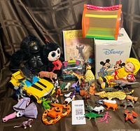 Overview of entire lot showing all toys, figurines, plush, containers and Disney box