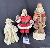 Front view of three Santa pieces side by side
