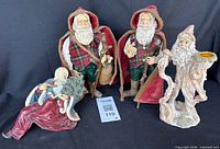 All four Santa figurines front view