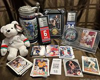overview of entire lot showing stein, teddy bear, mini sticks, coin displays and cards