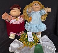 Front view of both dolls with accessories visible