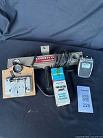 All items grouped: film splicer, movie light bar with cord, Sylvania lamp box, black flash