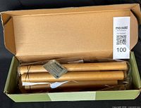 Open box showing wooden chime tubes in plastic sleeve