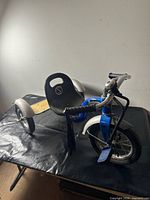 Full view of blue Roadster tricycle showing overall design and components