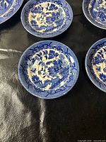 Close-up of Blue Willow small plates showing pattern and wear