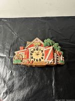 Front view showing overall barn scene design and clock face