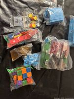 All bags of manipulatives laid out on black surface