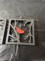 Black metal frame with red bird insert