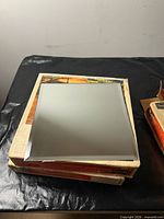 Stack of two Sears boxes with one mirror tile on top