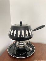 complete fondue set assembled showing lotus patterned pot on stand and underplate