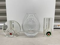 Group shot of three clear glass vases