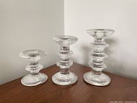Front view of three Festivo candlesticks showing graduated heights and ring counts