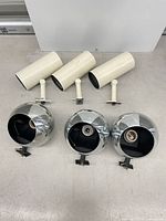 Overview of all six Lightolier track heads – three cream cylindrical and three chrome eyeball units