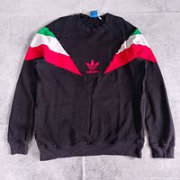 Full front view showing black sweatshirt, chevron stripes, red adidas logo