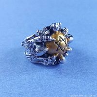 Front view of clawed gold skull ring with pentagram