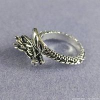 Side view of silver-plated dragon wrap ring showing coiled design and texture