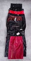 Stack of fifteen faux leather skirts laid flat