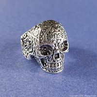 Front view showing full skull design and silver tone
