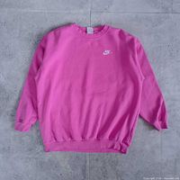 Front view of pink Nike crewneck sweatshirt