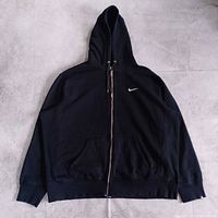 Front view of black Nike full-zip hoodie showing overall design, pockets, and embroidered Swoosh