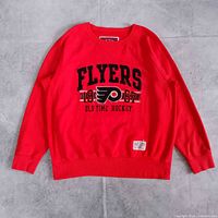 Full front view of orange Flyers crewneck sweatshirt