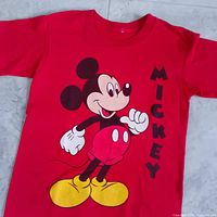 Three-quarter view highlighting Mickey Mouse graphic and vertical text