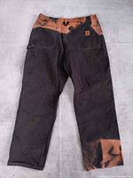 Full front view of bleach-dyed Carhartt work pants