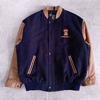 Full front view of navy wool and tan leather varsity jacket