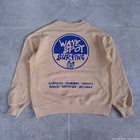 Full back view of light yellow sweatshirt showing Wave Spot Surfing graphic and overall condition