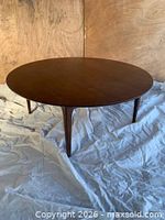 Full view of round walnut coffee table showing overall design