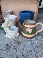 Group view showing rabbit planter, watering can planter and blue dimple planter