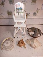 All items including lifeguard chair, metal bowl with stones, shell basket, conch, scallop shell