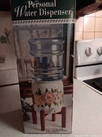 retail box showing assembled personal water dispenser