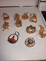 All ten gold-tone ornaments grouped together