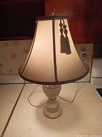 Full view of lamp on countertop showing base, shade, cord