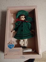 Doll in original box with stand and hangtag visible