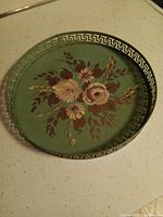 Top view showing floral design and Greek key rim