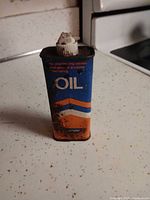Front view of Norton oil can showing graphics and spout