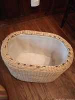 Interior of wicker ottoman showing white fabric lining