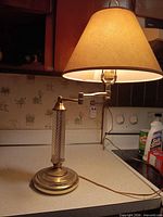 Overall view of brass table lamp illuminated on countertop
