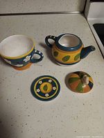 teapot body, sugar bowl body, two lids displayed