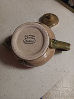Bottom view displaying maker’s mark and glaze condition