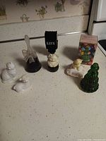 Group shot showing all seven Avon collectible perfume bottles