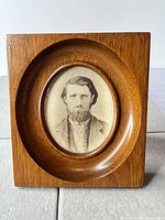 Front view of wood frame with oval cabinet card portrait
