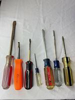 All six screwdrivers laid out to show size range and handle colors