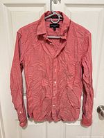 Full front view of coral Banana Republic shirt on hanger