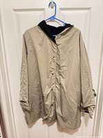 Front view of beige hooded coat on hanger