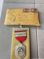 Medal on wood mount with original envelope