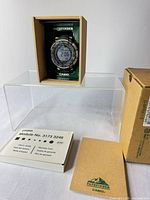 Watch in presentation box with manual, warranty card and outer sleeve visible